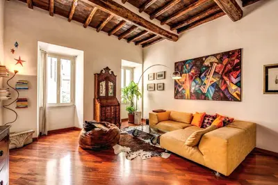 a living room with a couch and a painting on the wall at Pellegrino in Rome