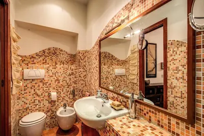 a bathroom with a sink and a toilet and a mirror at Pellegrino in Rome