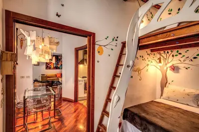 a bedroom with a tree mural on the wall at Pellegrino in Rome