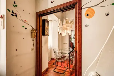 a dining room with a glass table and a mirror at Pellegrino in Rome
