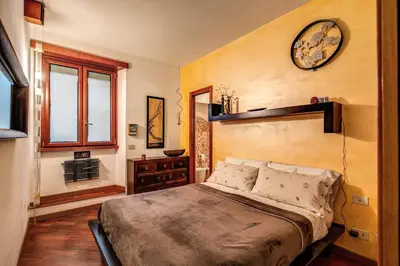 a bedroom with a bed and a clock on the wall at Pellegrino in Rome