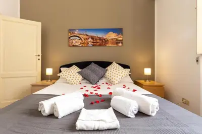 a bedroom with a bed with red roses on it at Elegant Apartment in the Center of Rome! in Rome