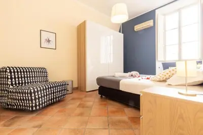 a bedroom with a bed and a chair at Elegant Apartment in the Center of Rome! in Rome