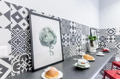 a room with a table with pastries and a mirror at MARCONI 94 - APARTMENT&PRIVATE ROOMS in Rome