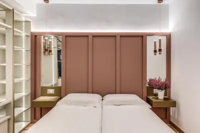 a bedroom with two beds and mirrors at Relais Trevi 95 Boutique Hotel in Rome