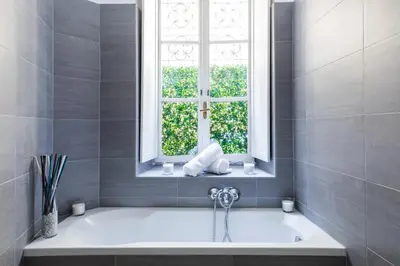 a bath tub in a bathroom with a window at A World Aparts - 32 Calabria in Rome