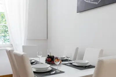 a dining room table with glasses and a bowl of fruit at A World Aparts - 32 Calabria in Rome