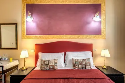 a bedroom with a red bed with two lamps at Beautiful Home in Rome