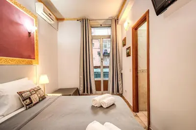a bedroom with a bed and a large window at Beautiful Home in Rome