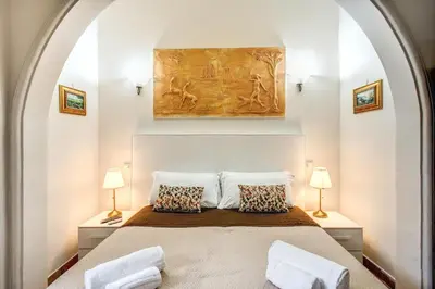 a bedroom with a large bed with two lamps at Beautiful Home in Rome