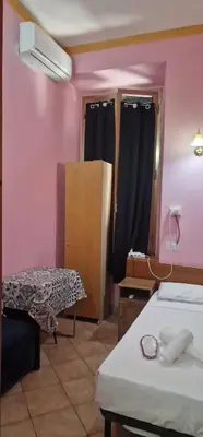 a room with two beds and a table and a mirror at Beautiful Home in Rome