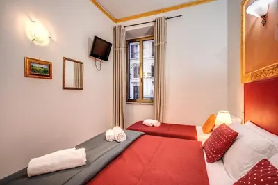 two beds in a room with red and white at Beautiful Home in Rome