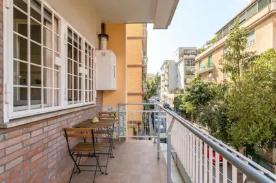 a balcony with tables and chairs on a building at Roman Style I near San Pietro in Rome