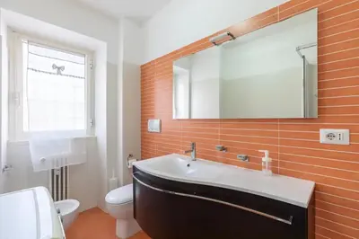 a bathroom with a sink and a toilet and a mirror at Roman Style I near San Pietro in Rome