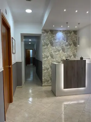 a hallway with a wall with a mural of flowers at San Paolo Guest House in Rome