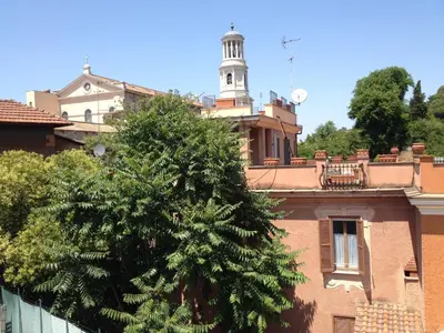 a tree in front of a building with a tower at San Paolo Guest House in Rome