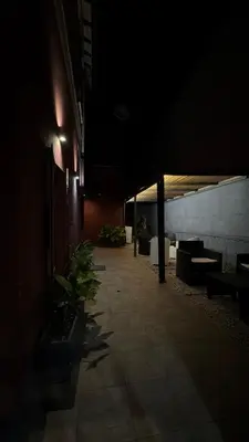 a dark hallway with benches in a building at night at San Paolo Guest House in Rome