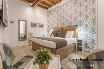 a bedroom with a bed and a table and chairs at CS Exclusive Campo de Fiori Palace in Rome