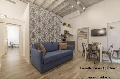 a living room with a blue couch and a table at CS Exclusive Campo de Fiori Palace in Rome