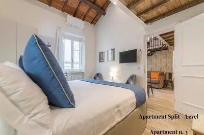 a bedroom with a king sized bed with a blue pillow at CS Exclusive Campo de Fiori Palace in Rome