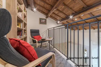 a room with a balcony with a chair and a table at CS Exclusive Campo de Fiori Palace in Rome