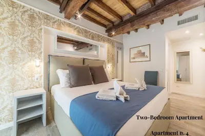 a bedroom with a bed with two white shoes on it at CS Exclusive Campo de Fiori Palace in Rome