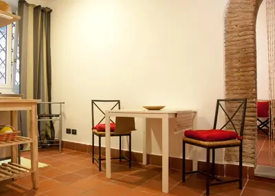 a table and chairs in a room with a table at TRASTEVERE - STUDIO APT. x 2 in Rome
