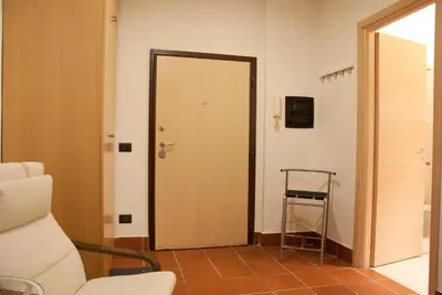 a room with a door and a chair and a stool at TRASTEVERE - STUDIO APT. x 2 in Rome