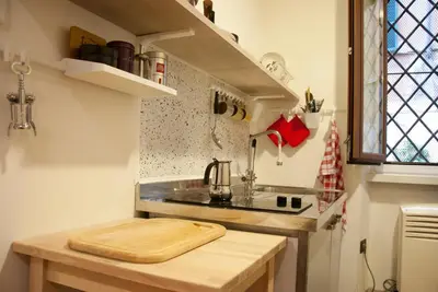 a kitchen with a cutting board on top of a counter at TRASTEVERE - STUDIO APT. x 2 in Rome