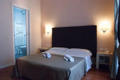 a bedroom with a bed with two towels on it at Elle Cavour Guest House in Rome