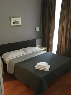 a bedroom with a bed with two towels on it at Elle Cavour Guest House in Rome