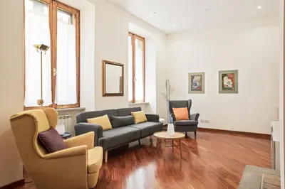 a living room with a couch and two chairs at BDC - Colosseum Superior Apartment in Rome