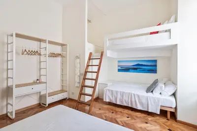 a bedroom with a bunk bed and a ladder at BDC - Colosseum Superior Apartment in Rome