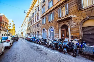 a row of motorcycles parked next to a building at BDC - Colosseum Superior Apartment in Rome