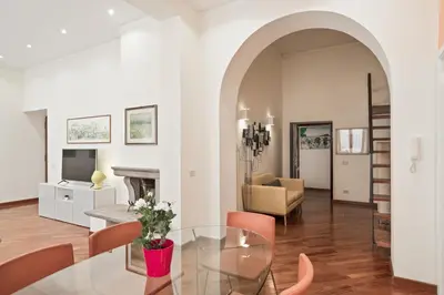a living room with a glass table and a fireplace at BDC - Colosseum Superior Apartment in Rome