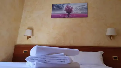 a bedroom with a bed with towels on it at Holiday Roma in Rome