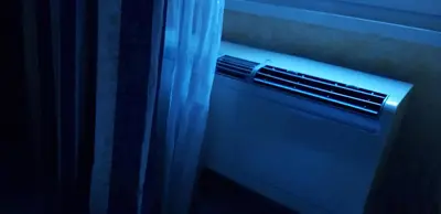 a air conditioner in a window next to a curtain at Holiday Roma in Rome
