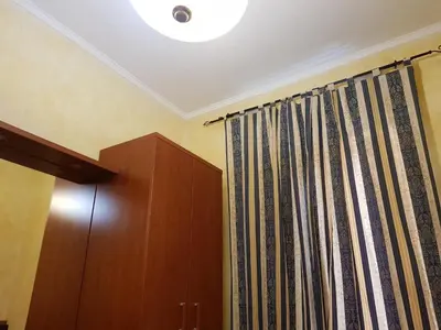 a room with a curtain and a cabinet and a ceiling at Holiday Roma in Rome