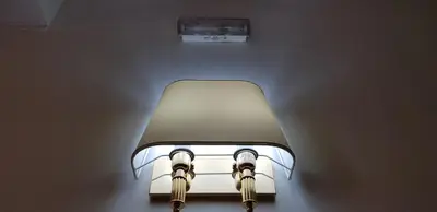 a light on a wall in a room at Holiday Roma in Rome