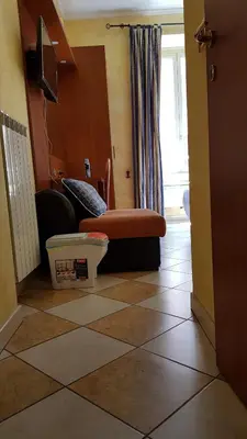 a living room with a tiled floor with a window at Holiday Roma in Rome