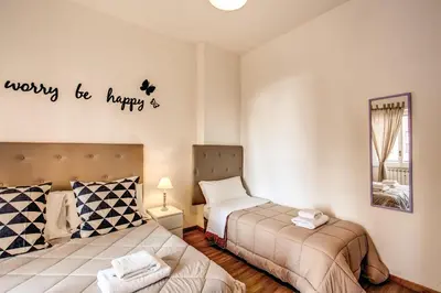 a bedroom with two beds and a sign that says ways to marry at Qflat Aura Paradise Vatican with parking garage in Rome