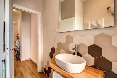 a bathroom with a sink and a mirror on the wall at Qflat Aura Paradise Vatican with parking garage in Rome