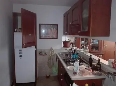 a kitchen with a stove and a white refrigerator at Esquilino Confort Roma in Rome