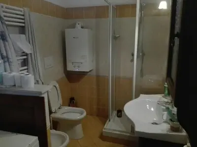 a bathroom with a toilet and a shower and a sink at Esquilino Confort Roma in Rome
