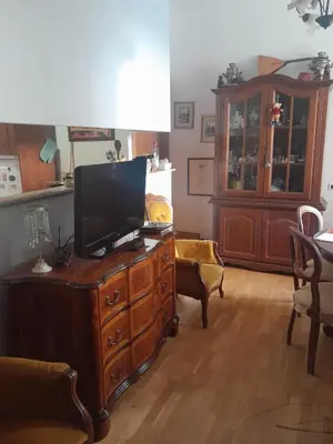 a living room with a television on a wooden dresser at Esquilino Confort Roma in Rome