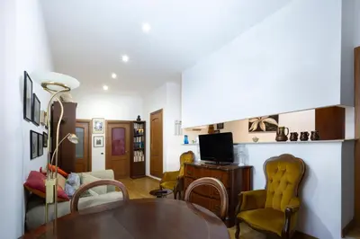 a living room with a table and chairs at Esquilino Confort Roma in Rome