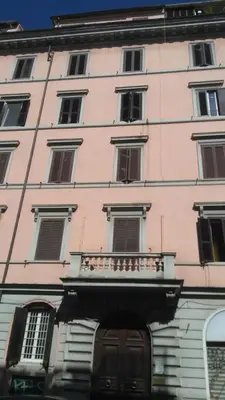 a pink building with a balcony in front of it at Esquilino Confort Roma in Rome
