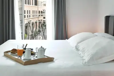 a tray with a breakfast on a bed with a window at Suite Art Navona in Rome