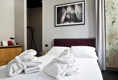 a bedroom with white towels on a bed at Suite Art Navona in Rome