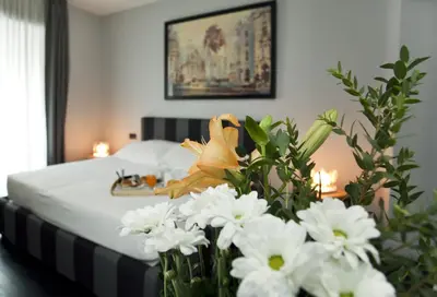 a bedroom with a bed with white flowers on it at Suite Art Navona in Rome